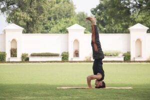 A man doing an inverted yoga pose